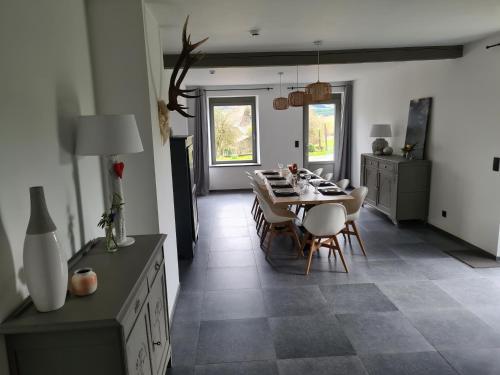 a kitchen and dining room with a table and chairs at Le Courtil in Bièvre