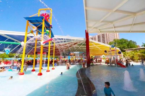 a water park with a water slide and a roller coaster at Piazza com acesso ao Acqua Park - Gustavo in Caldas Novas