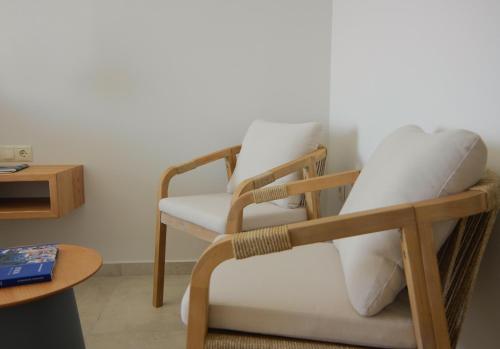 a rocking chair in a room with a table at Floris Manor in Ermoupoli