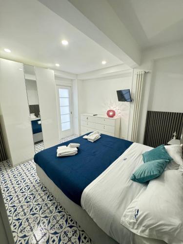 a bedroom with a large bed with towels on it at Panoramic Flat Amalfi Coast - Sea View 1 in Vietri sul Mare