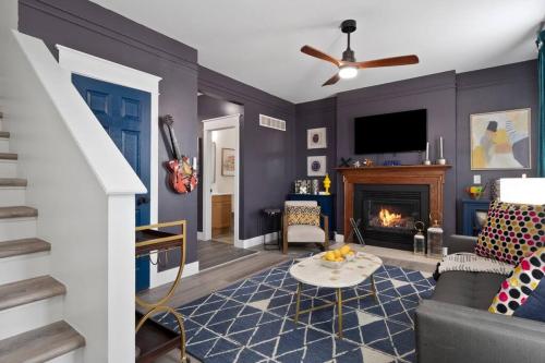 a living room with a couch and a fireplace at Modern Escape: 5BR/2.5BA Near St. Louis Must-Sees in Saint Louis