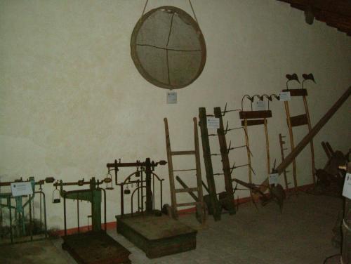 a room with a bunch of equipment on the wall at Castel Pietraio WineResort in Monteriggioni