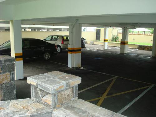 a car parked in a parking lot with columns at Immeuble Rayon Vert in Flic-en-Flac