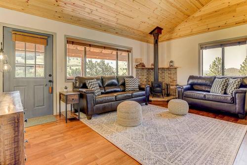 a living room with leather furniture and a wooden ceiling at Monarch Landing, A Cozy Cabin w/360 Mountain Views in Cripple Creek