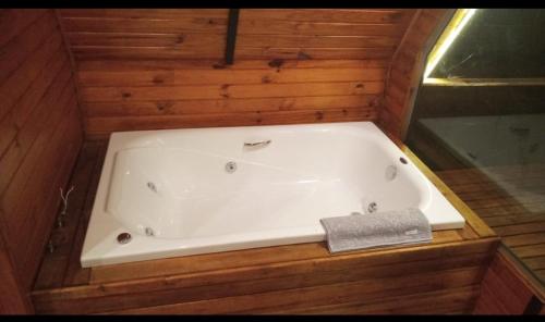 a bath tub sitting in a wooden room with at ECO PARK ALTA MIRA in São Francisco de Paula