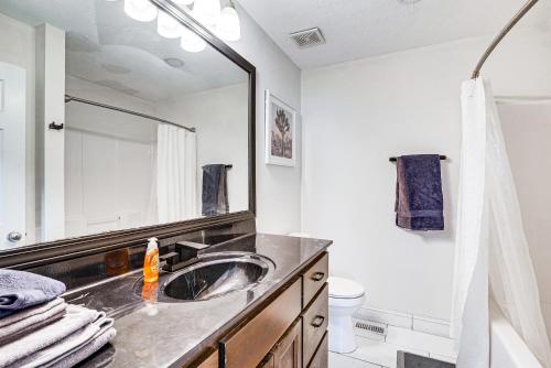 a bathroom with a sink and a mirror at Bowling Green Duplex Rental about 5 Mi to Downtown! in Bowling Green