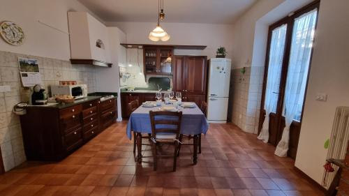 a kitchen with a table with wine glasses on it at A casa di Gina in Rosignano Solvay