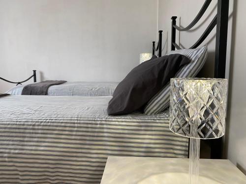 a bedroom with a bed with a black frame and pillows at Casa d'artista in Val di Chiana in Sinalunga