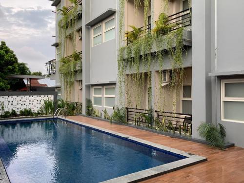 a swimming pool in front of a building at AJ BOUTIQUE HOTEL in Yogyakarta