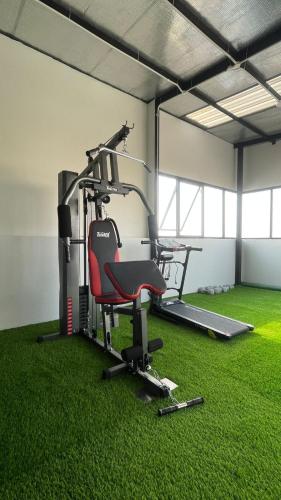 a gym with a treadmill and a chair on the grass at AJ BOUTIQUE HOTEL in Yogyakarta