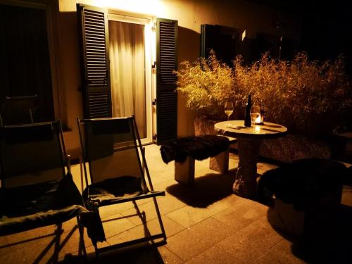 a patio with a table and chairs at night at Aparthotel "Goldener Hahn Apartments" in Bad Waltersdorf