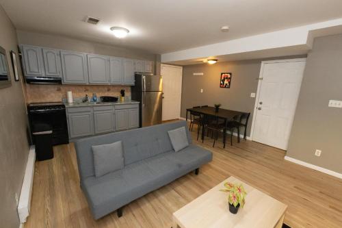 a living room and kitchen with a couch and a table at Pleasing 4- Bed Apartment Close to NYC in Jersey City