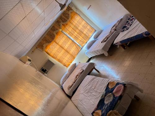 an overhead view of a room with two beds and a window at Addis Guest House Djibouti in Djibouti