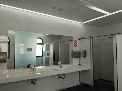 a bathroom with two sinks and two mirrors at Mondragón in Puerto de Mogán