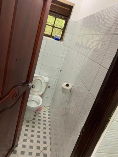 a bathroom with a toilet and a window at Mpanga Nature Center in Mpigi