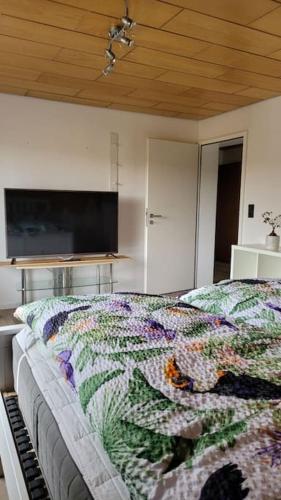 a bedroom with a bed with a colorful quilt on it at Apartment Schwarzwaldmädel in Friedenweiler