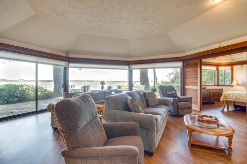 a living room with a couch and chairs and a table at Enchanting Coos Bay Sanctuary with Lush Views! in Coos Bay