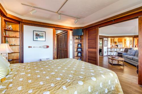 a bedroom with a bed and a living room at Enchanting Coos Bay Sanctuary with Lush Views! in Coos Bay
