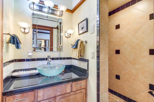 a bathroom with a sink and a shower at Enchanting Coos Bay Sanctuary with Lush Views! in Coos Bay