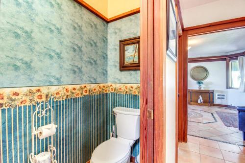 a bathroom with a toilet and a shower at Enchanting Coos Bay Sanctuary with Lush Views! in Coos Bay