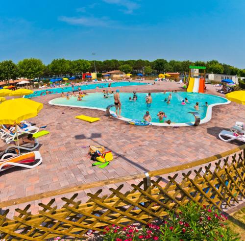 a pool with people swimming in it at Campeggio del Garda in Peschiera del Garda