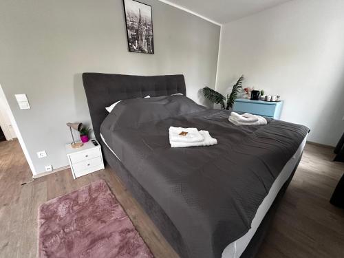 a bedroom with a bed with two towels on it at Premium Apartments Schwetzingen, Heidelberg, Speyer in Schwetzingen