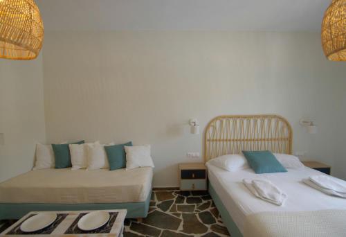 a bedroom with two beds with hats and towels on them at Remvi in Galissas