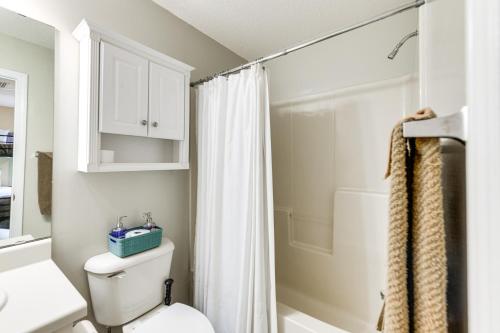 a bathroom with a white toilet and a shower at Abbeville Cottage with Grill Steps to Lake Eufaula! in Abbeville