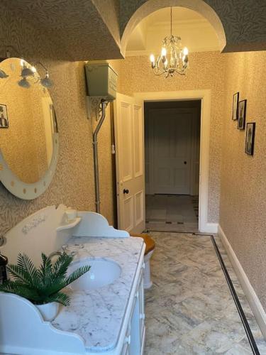a bathroom with two sinks and a large mirror at Edenfield House, Springfield, Fife in Cupar