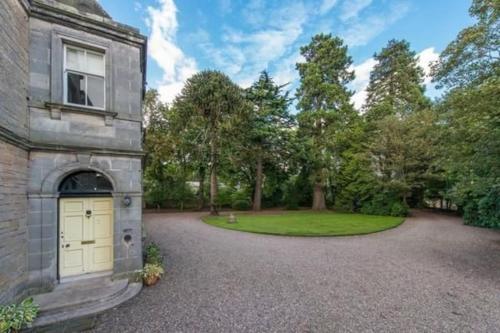 an exterior view of a house with a driveway at Edenfield House, Springfield, Fife in Cupar