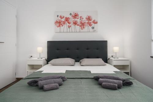 a bedroom with a large bed with two pillows on it at Villa Diamond in Trogir