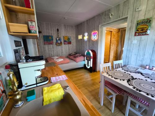 a kitchen with a table and a room with a couch at Ranch 66 - Zlatokopecká chata Arizona in Tršice