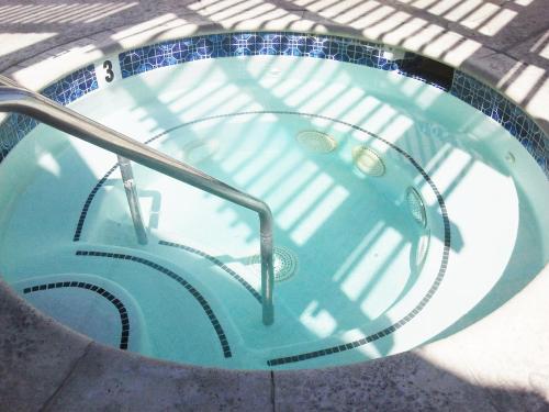 a jacuzzi tub with a metal hand rail at Super 8 by Wyndham Santa Clarita/Valencia in Santa Clarita