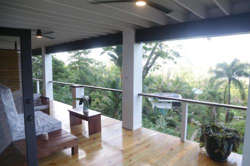 a balcony with a view of the forest at Roam Yoga & Wellness Lodge in Bocas del Toro