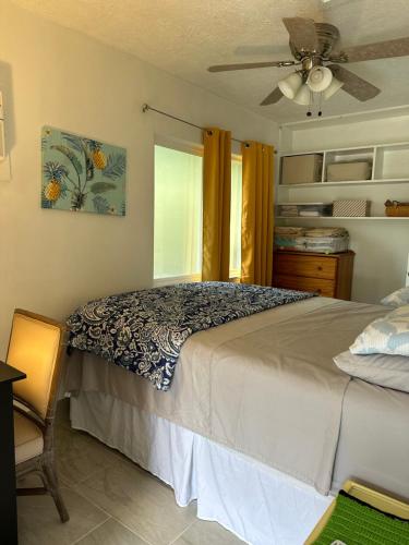 a bedroom with a bed and a ceiling fan at The Cottage at Ohia Kai. TVNCU#1354 in Kapaa