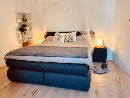 a bedroom with a large bed with a canopy at Wellness-mit-Stil in Schwerte