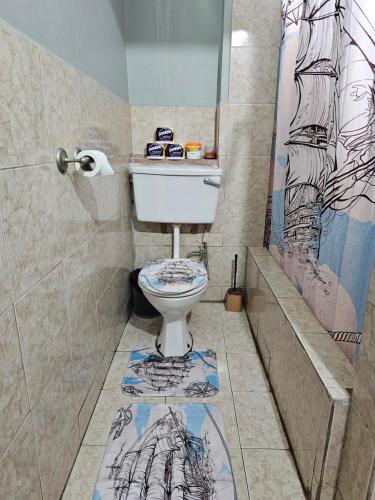 a bathroom with a toilet and a shower at 2br Apt in St Helena - 6mins from the airport Perfect for short and long stays in Piarco