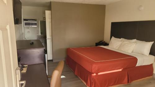 a hotel room with a bed and a desk at Econo Lodge Las Vegas in Las Vegas