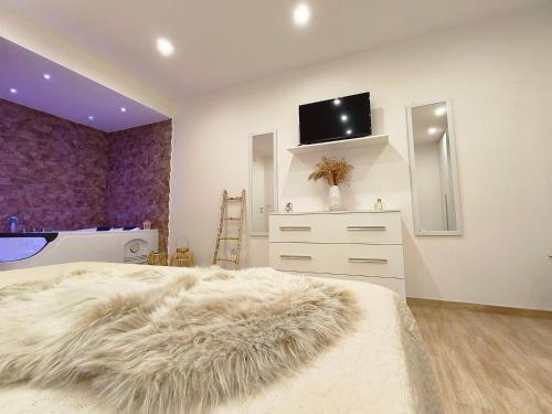 a bedroom with a bed and a tv on a wall at House La Torricella in Vetriolo