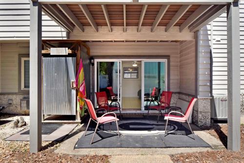 a patio with chairs and a table with a flag at HG Coastal in Demere Park