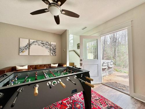 a living room with a large pool table at The Cove Retreat- Hot Tub/Screened Porch/Game Room in Lake Lure