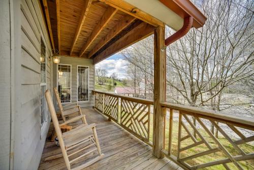 a screened porch with two chairs on a house at Peaceful Guntersville Cabin Fire Pit, Near Lake! in Guntersville