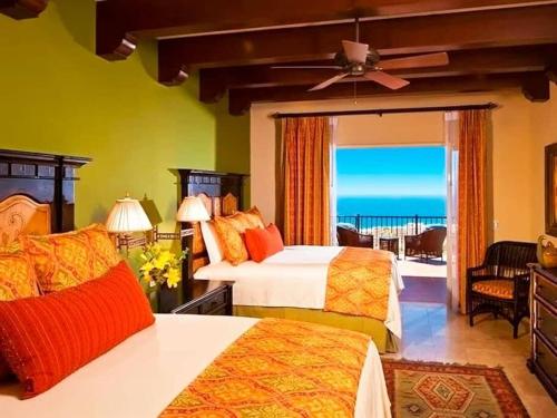 a bedroom with two beds and a view of the ocean at Gorgeous 3BR Villa Perfect View at Cabo San Lucas in Cabo San Lucas