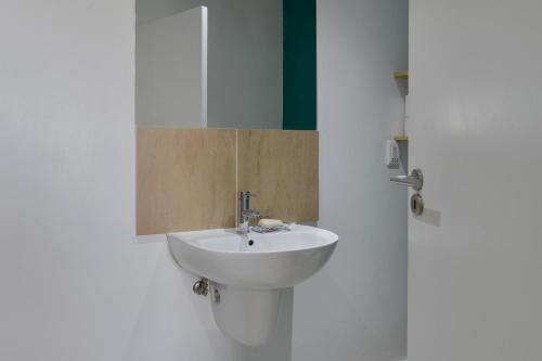 a bathroom with a white sink and a door at 108 Waverley in Cape Town