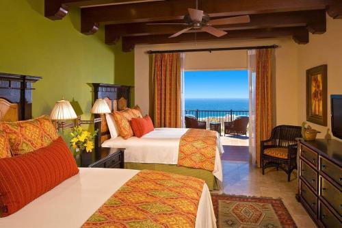 a bedroom with two beds and a balcony with the ocean at Superb 3BR Villa Great view at Cabo San Lucas in Cabo San Lucas