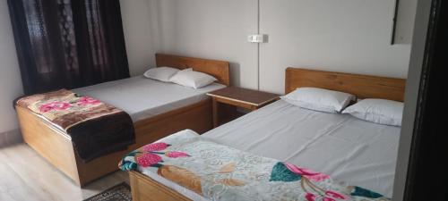 a bedroom with two beds and a couch at Crystal Cottage in Pedong
