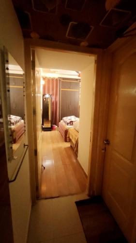 a hallway leading to a bedroom with two beds at Boutique Stay for Family On Manali Expressway in Lāndrān