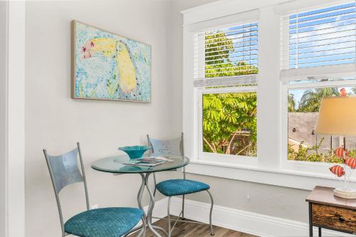 a table and chairs in a room with a window at Birds of Paradise: Unwind in Nature's Embrace in Lantana