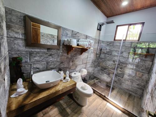 a bathroom with a sink and a toilet and a shower at Cabañas Caeli, El Congo, La Fortuna Rainforest Glass Cabin w Suite in Fortuna