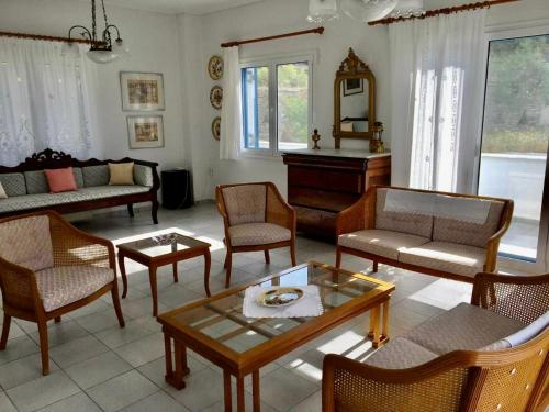 - un salon doté de meubles et d'un piano dans l'établissement Villa Sis, à Aïdhónia